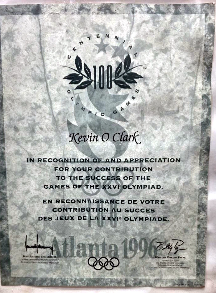 Framed certificate: Kevin O Clark, in recognition of and appreciation for your contribution to the success of the Games of the XXVI Olympiad — Centennial Olympic Games, Atlanta 1996